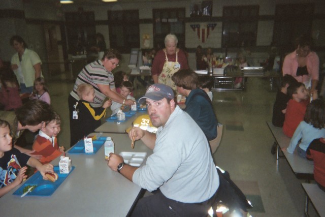 Chris having lunch with the kids after an AFA at the school